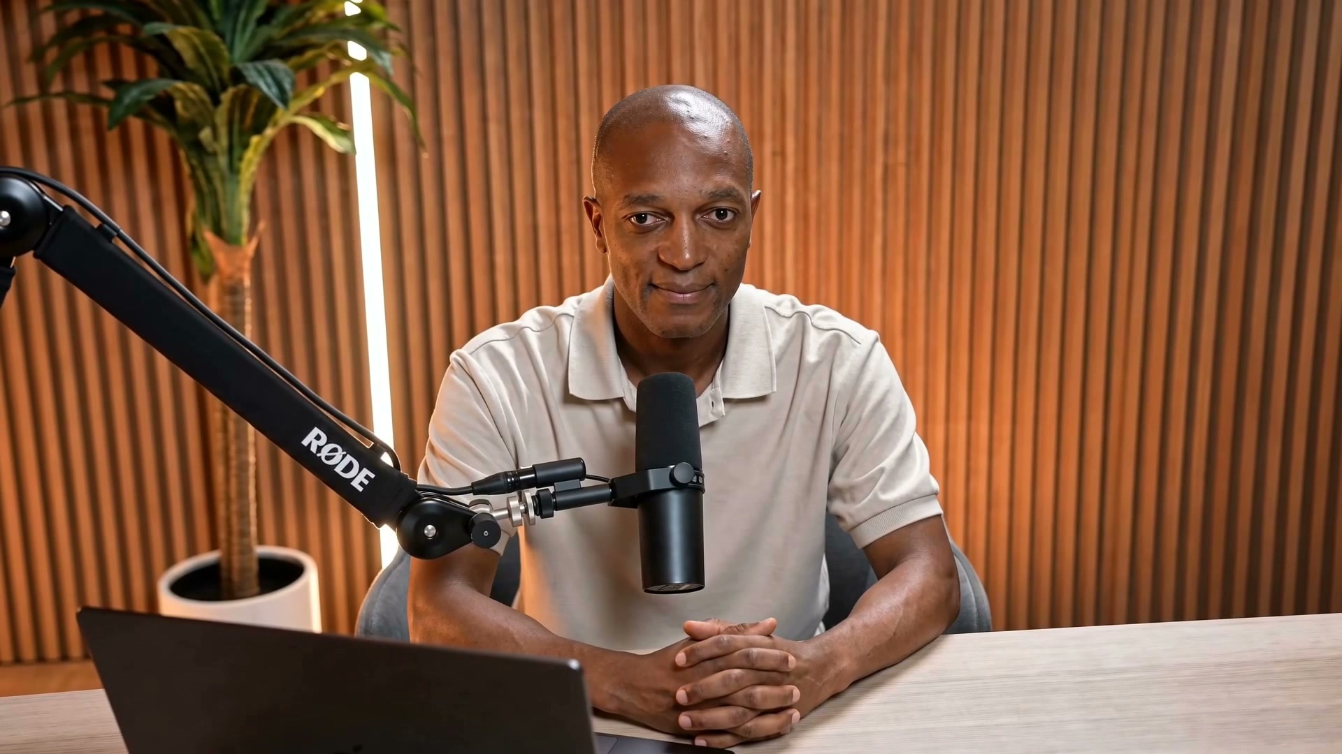 Komey Tetteh recording market research commentary in his studio