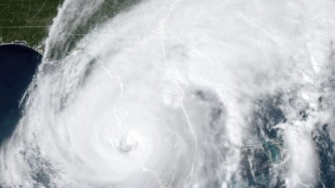 Aerial view of Southwest Florida coastline with storm clouds forming over the Gulf of Mexico, illustrating hurricane and climate risk exposure